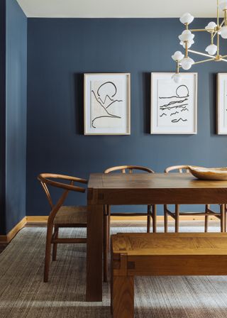 A dining room with a set of framed art