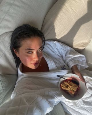 Sasha Mei in a Saie Beauty bathrobe with glowy skin and healthy-looking hair.