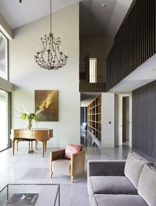 A contemporary double height living room with a chandelier