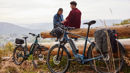 2 people standing on bikes