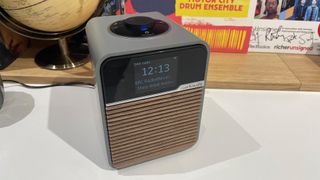 Ruark Audio R1S DAB radio top down slight angle on white shelf in front of globe