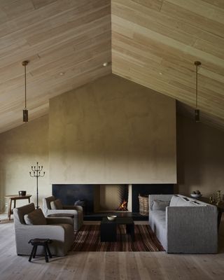 living room with textured brown walls an open fire