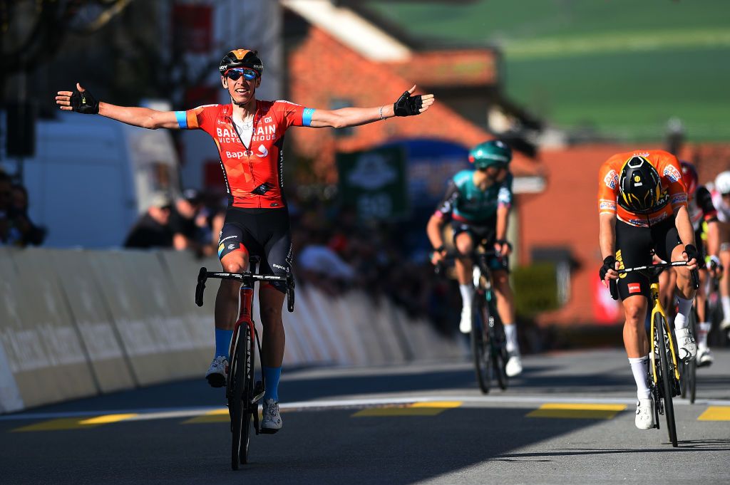 ROMONT SWITZERLAND APRIL 27 LR Dylan Teuns of Belgium and Team Bahrain Victorious celebrates winning ahead of Rohan Dennis of Australia and Team Jumbo Visma orange points jersey during the 75th Tour De Romandie 2022 Stage 1 a 178km stage from La Grande Beroche to Romont 777m TDR2022 on April 27 2022 in Romont Switzerland Photo by Dario BelingheriGetty Images