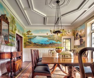 formal dining room with polished wood table and chairs and mural with ceiling beams