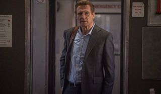 The Commuter Liam Neeson walking between trains with a puzzled look