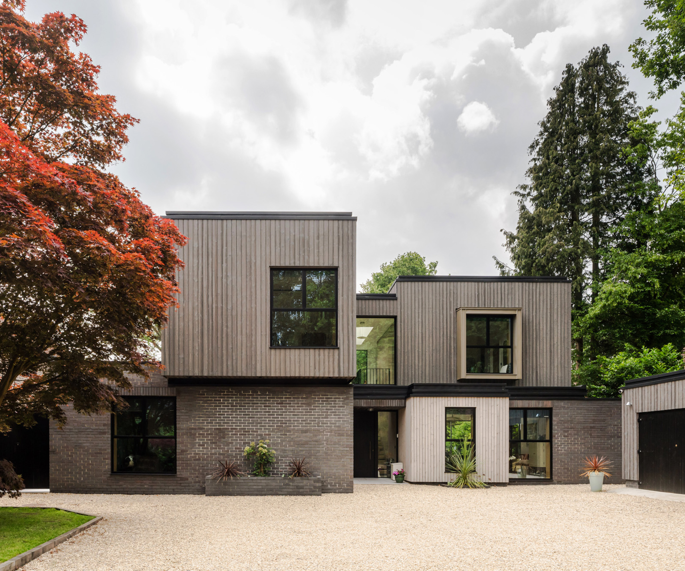 Front exterior of a contemporary self build home with bold geometric forms
