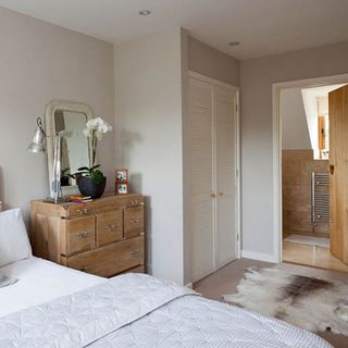 white bedroom with reindeer hide rug