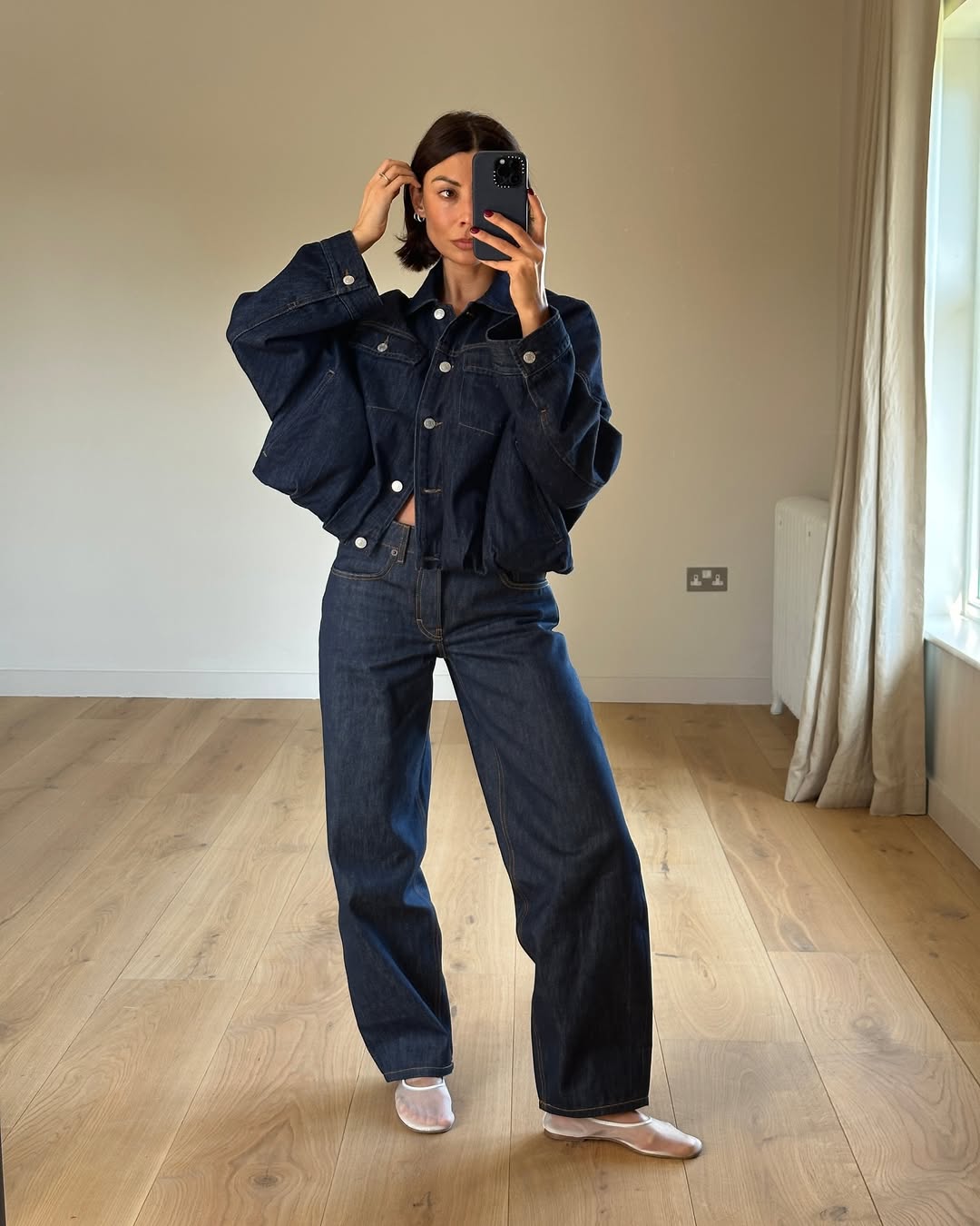 Influencer Marianne Smyth wearing dark wash denim and mesh ballet flats.