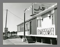 A black and white photograph of a trailer home
