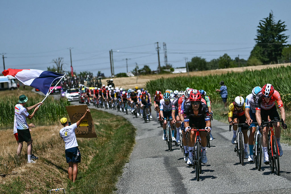 Tudor Pro Cycling Team's Italian rider Matteo Trentin (L) leads the pack of riders (peloton) during the 12th stage of the 112th edition of the Tour de France cycling race, 180.6 km between Auch and Hautacam, in the Pyrenees mountains of southwestern France, on July 17, 2025. (Photo by Marco BERTORELLO / AFP)