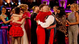 The Strictly 2024 cast and hosts gather around Wynne Evans and Katya Jones after they've been eliminated