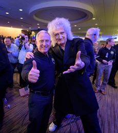 Two people stretch hands toward the camera enthusiastically