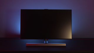 The Philips Momentum 279M1RV with ambiglow in a dark room.
