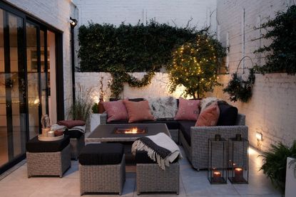 Corner Sofa with fire pit coffee table in a backyard