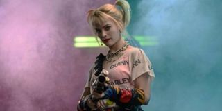 Margot Robbie as Harley Quinn aims a gun in Birds of Prey