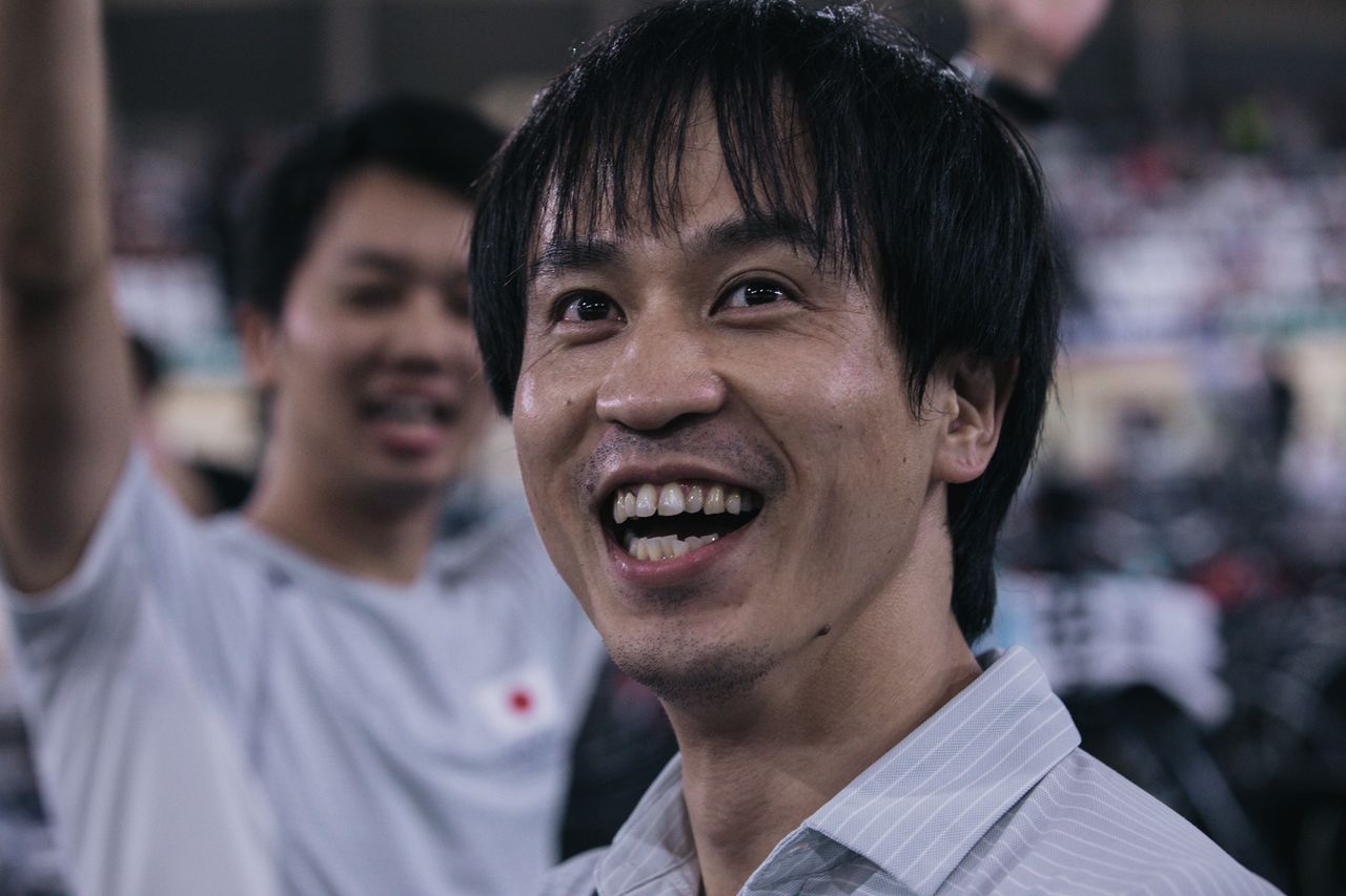 Japan's staff react to the men winning the team sprint