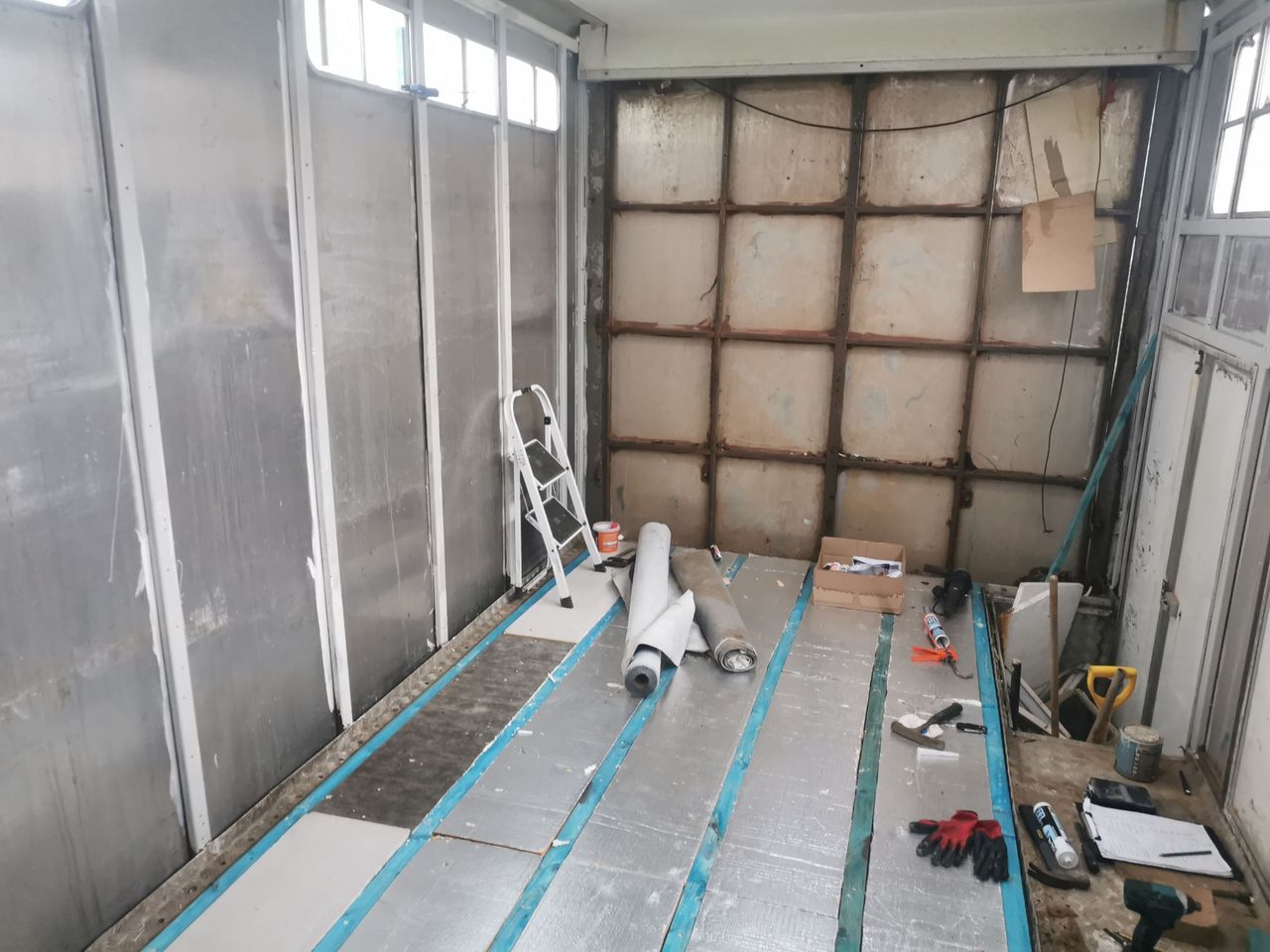The walls inside the caravan being stripped back