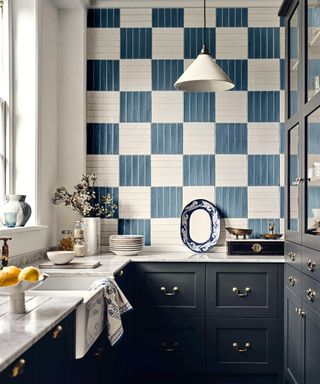 Navy Shaker kitchen with decorative blue and white wall tiles