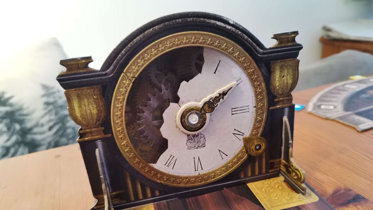 The cardboard Mysterium clock, with the hand pointing to 2