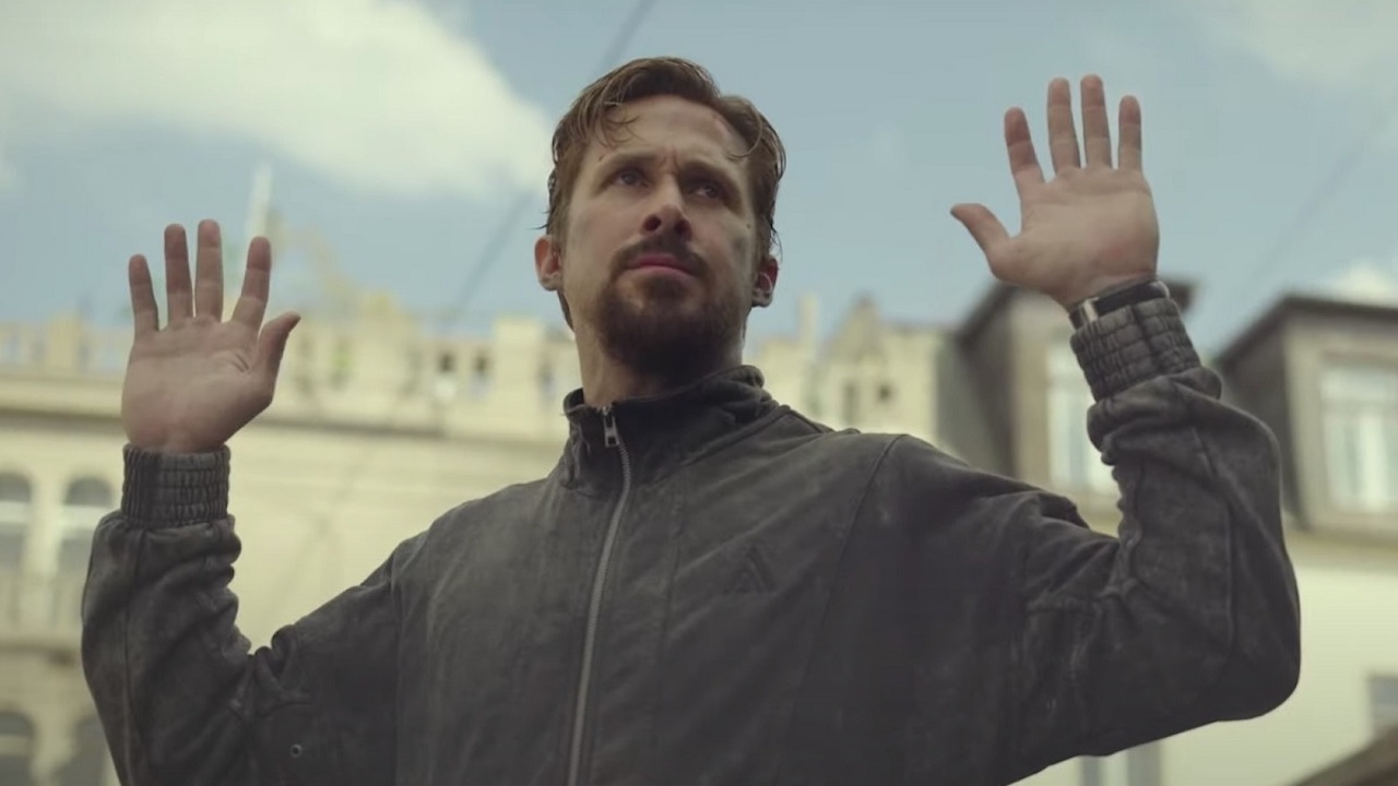 Ryan Gosling raises his hands in The Gray Man