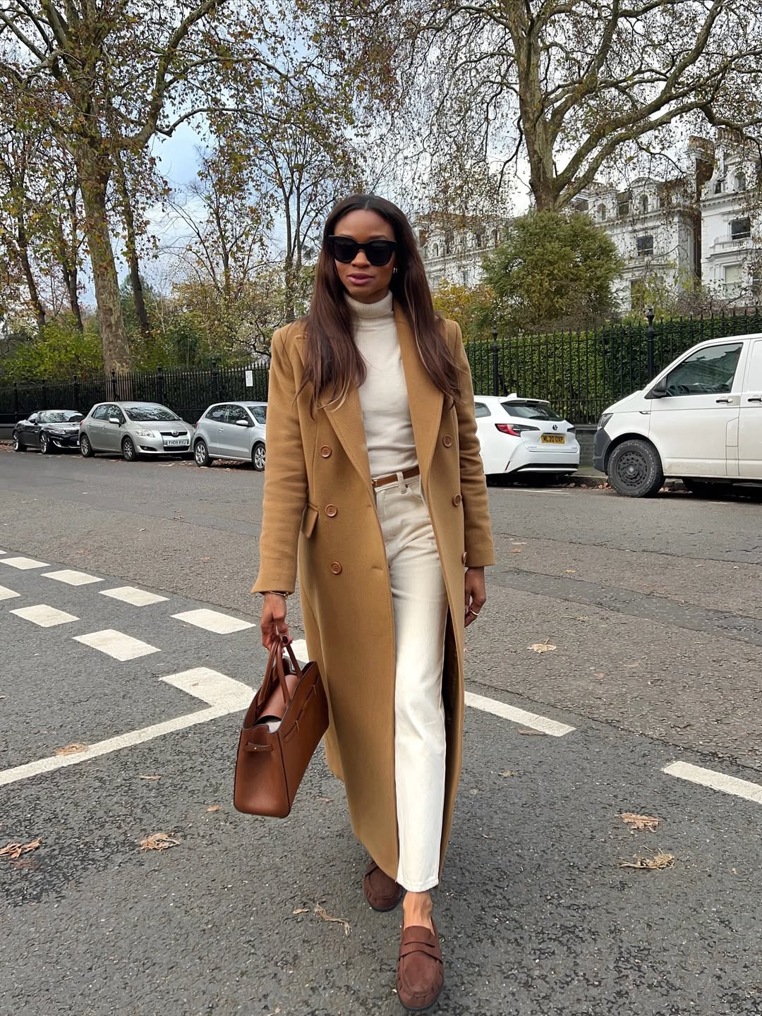 Lorna Symphony wearing brown suede loafers.