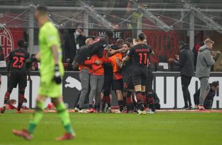 AC Milan players celebrate Koray Gunter's own goal