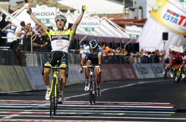 Gatto celebrates with Contador just behind and the peloton further back