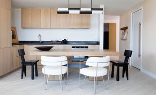 Kitchen / Dining area with 2 modern white chairs and 2 black chairs