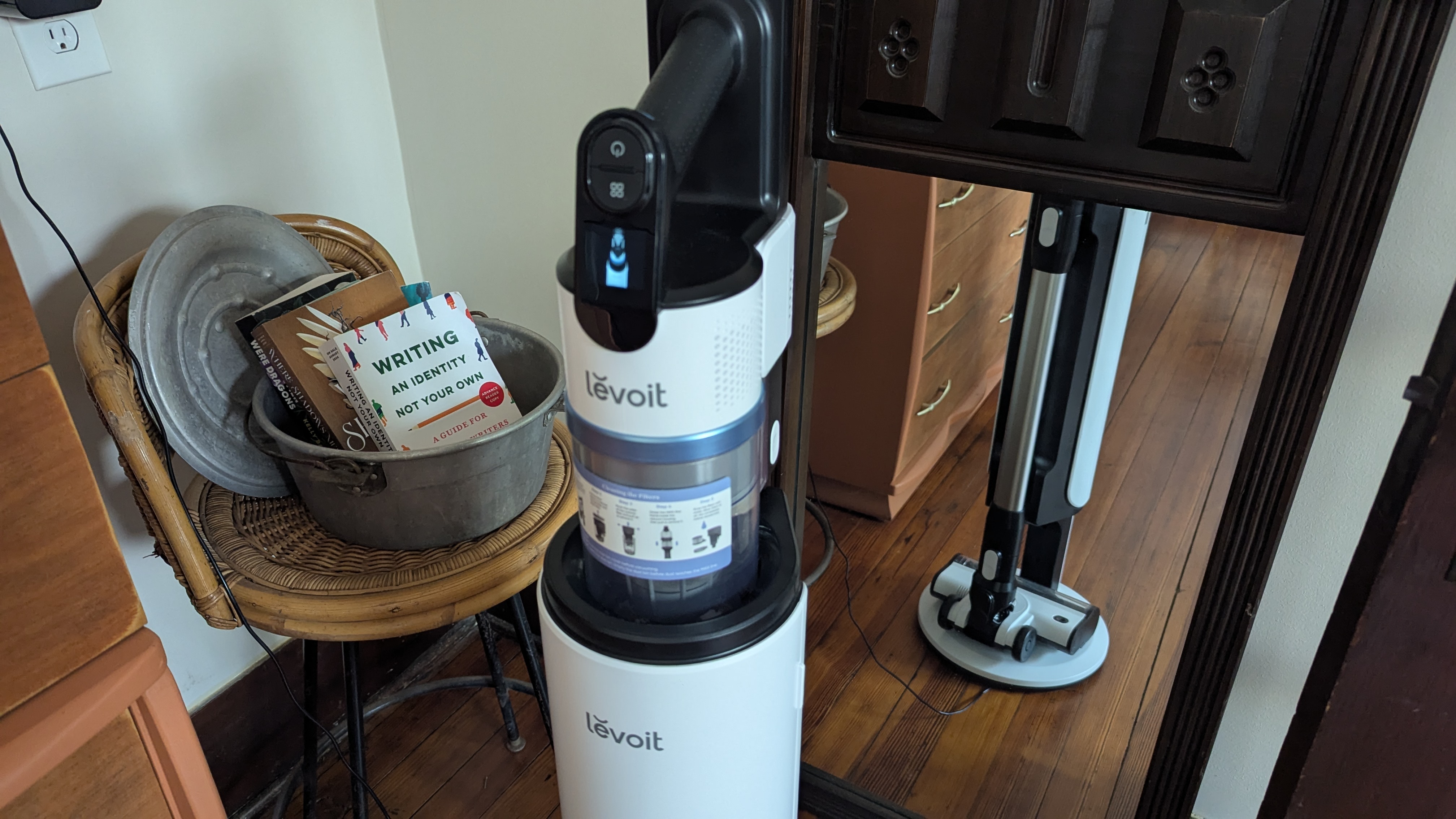 Levoit Aero vacuum in its charge / auto-empty dock, in reviewer's lounge