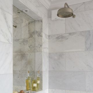 bathroom with large mirror on wall and tiled walls