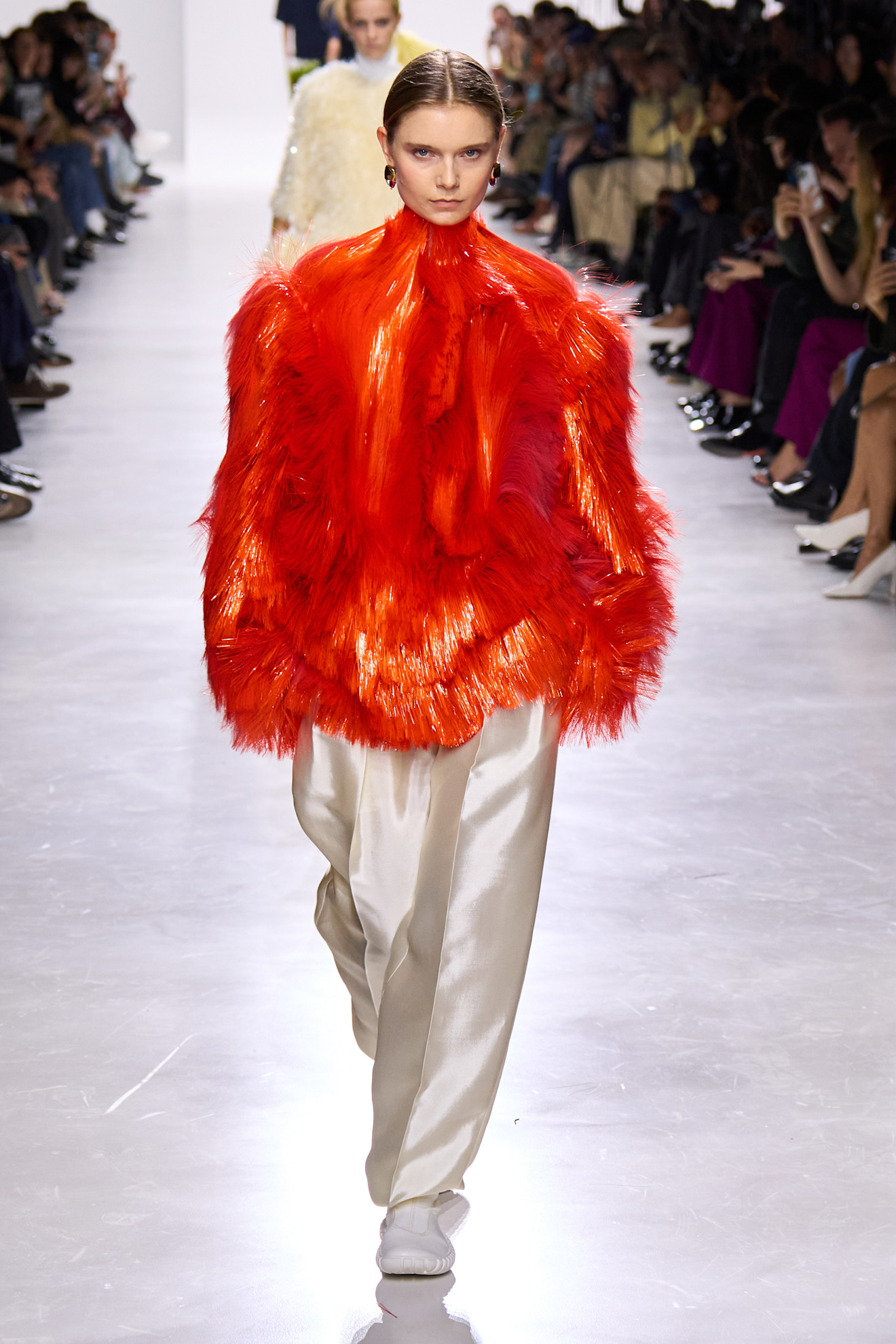 A model wears a fiberglass coat on the Bottega Veneta Spring 2026 runway