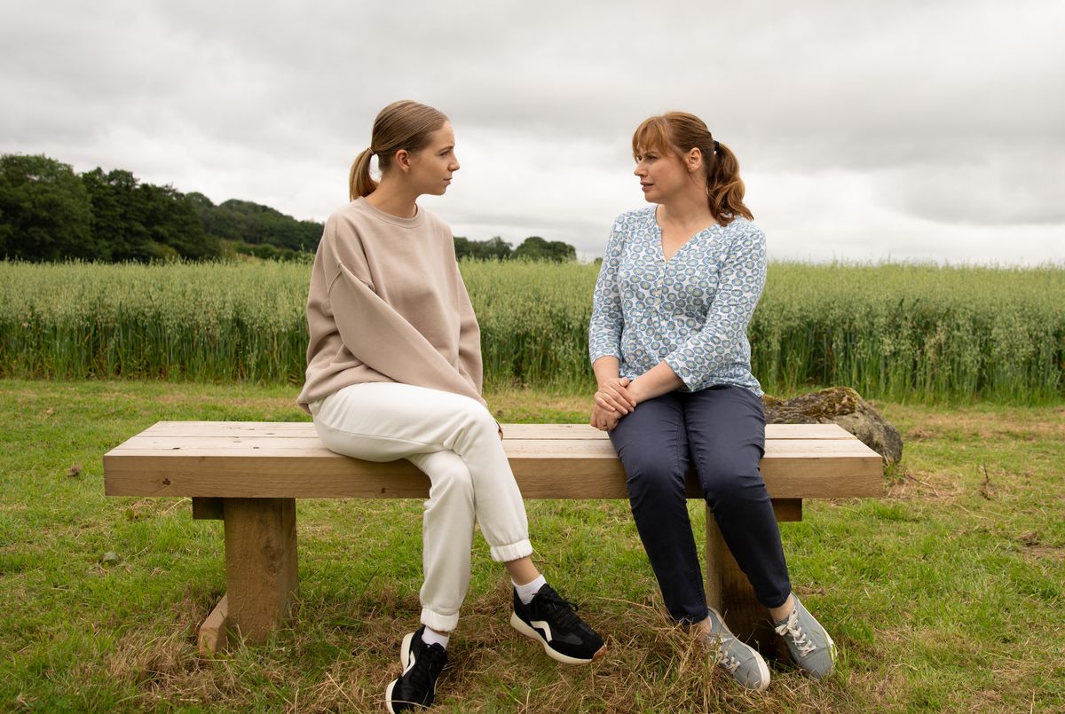 Belle and Lydia chatting in the countryside in Emmerdale 