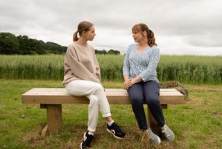 Belle and Lydia chatting in the countryside in Emmerdale 