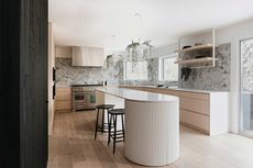 a modern kitchen with a ribbed rounded kitchen island