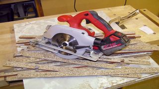 Circular saw uses in cutting wood on workbench