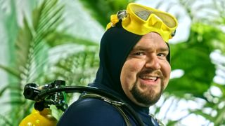 Dave the Diver, in live-action, smiling and wearing diving gear
