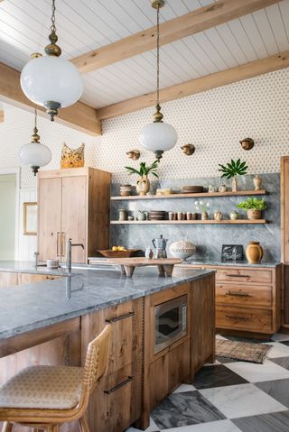 kitchen with large chequerboard flooring wooden cabinetry and antique style lighting