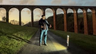 zhiyun fiveray f100 light stick in use on location in front of a viaduct