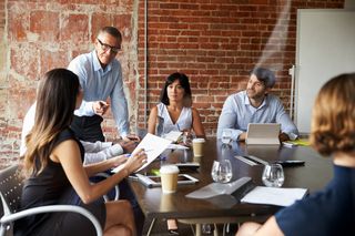 People sitting around a table having a meeting