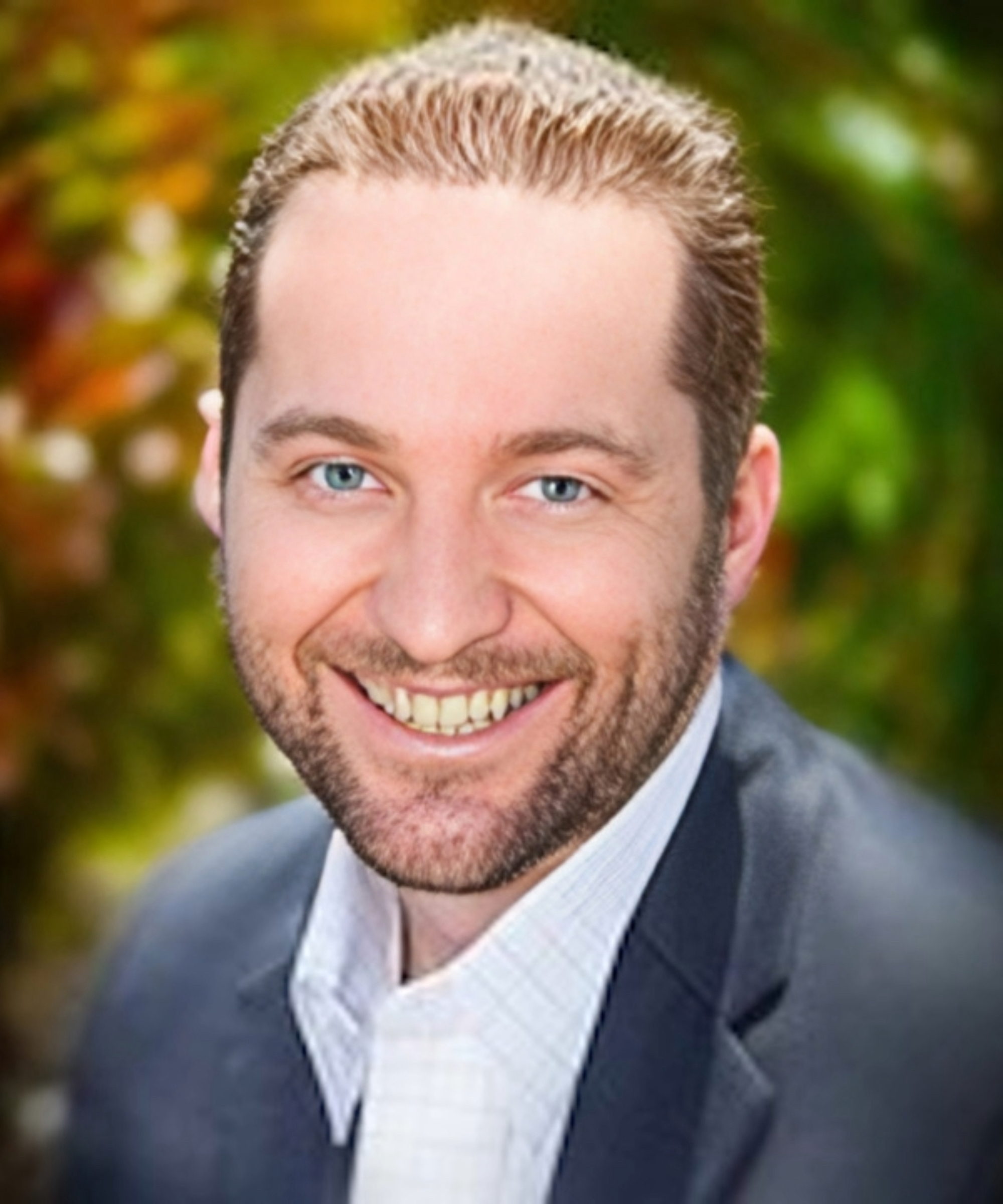 Dara Greaney is a man with medium brown hair and beard and moustache pictured head and shoulders and wearing a jacket and shirt