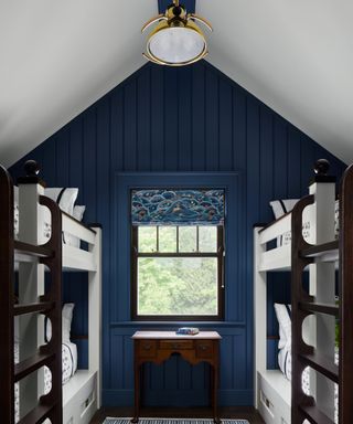 bunk room blue walls sloping roof white bunks