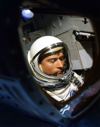 Gemini 3 pilot John Young seen through the hatch window of his spacecraft prior to launch in 1965.