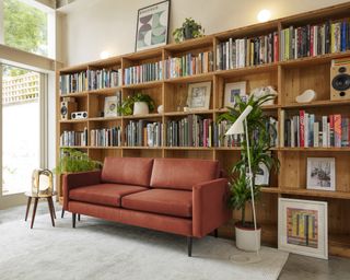A living room with brown sofa idea with orange-brown sofa and large bookcase