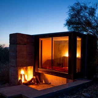boxy cabin with glass wall and fireplace
