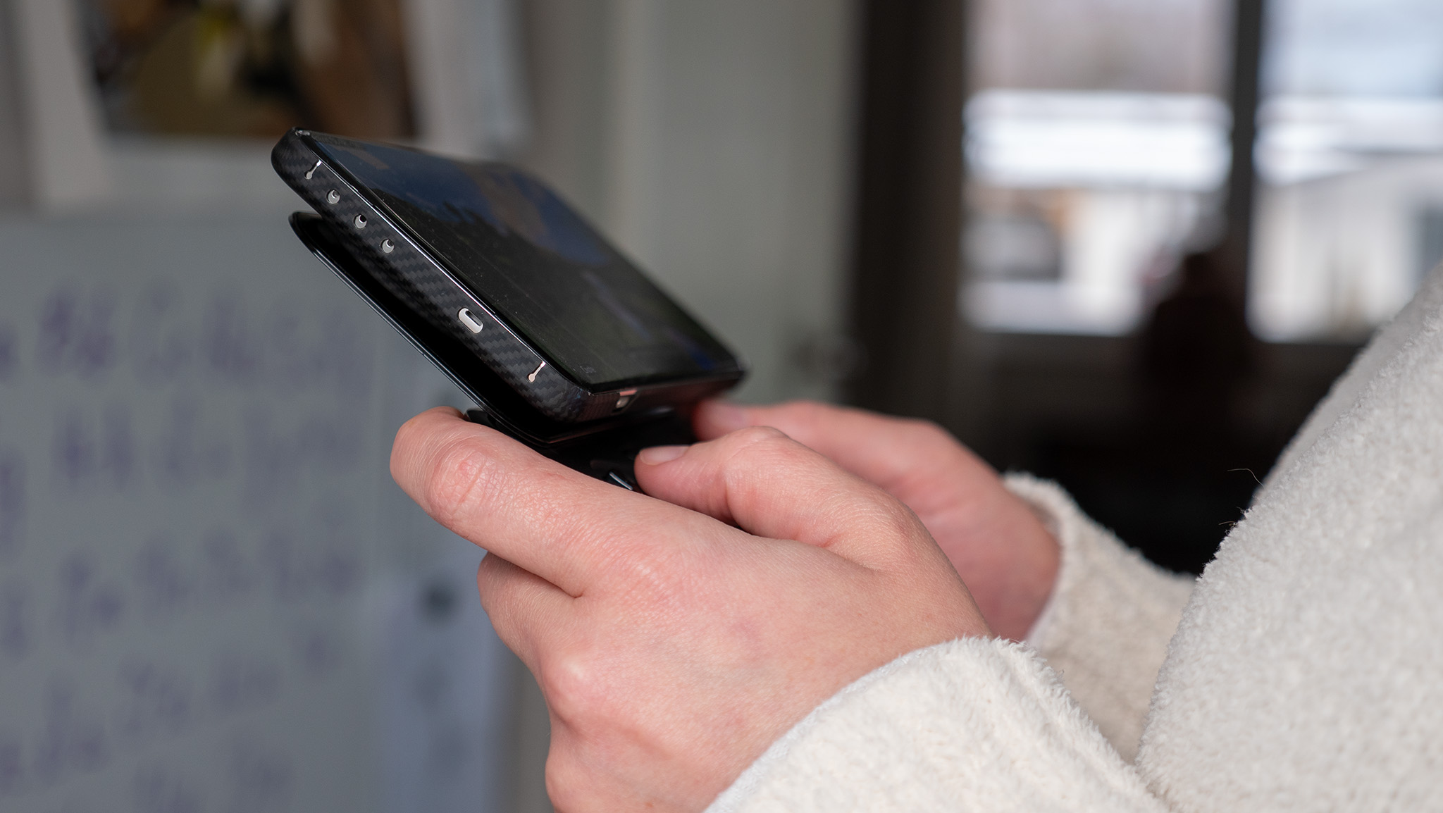 Playing Minecraft on a OnePlus 13 with a Thinborne case and a black Ohsnap MCON controller