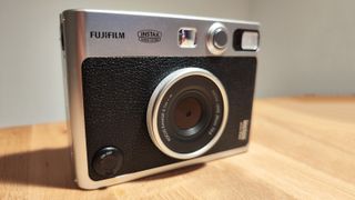 The Fujifilm Instax Mini Evo on a wooden table