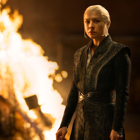 Emma D'Arcy as Rhaenyra Targaryen, standing in front of a large bonfire at night, in 'House of the Dragon' season 3.