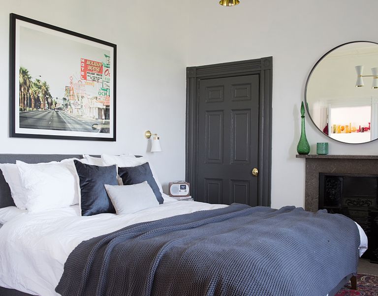 bedroom in a period home with mix of vintage and modern and grey bedspread