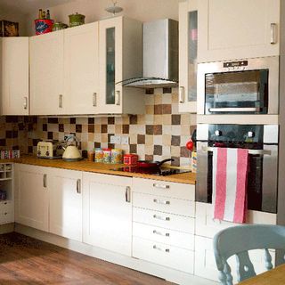 kitchen with units with wooden worktops retro inspired storage tins tea towels and accessories