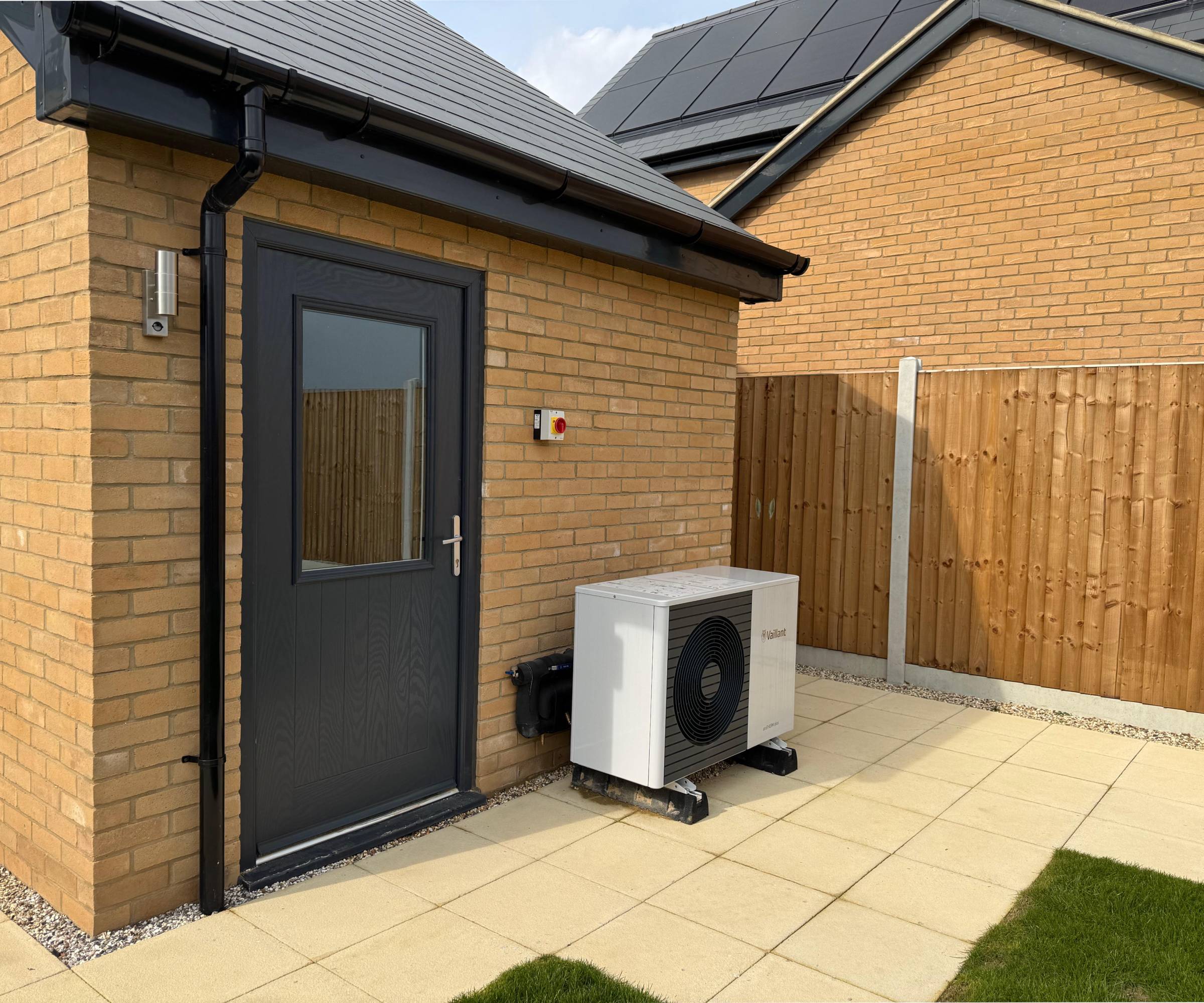 rear of property with heat pump located next to back door